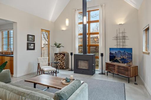 Living room features a wood burning fireplace and vaulted ceilings