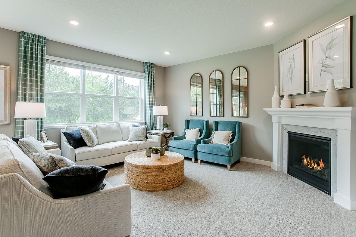Soaring windows flood your main level family room in natural light - a space punctuated by a glowing corner gas fireplace.