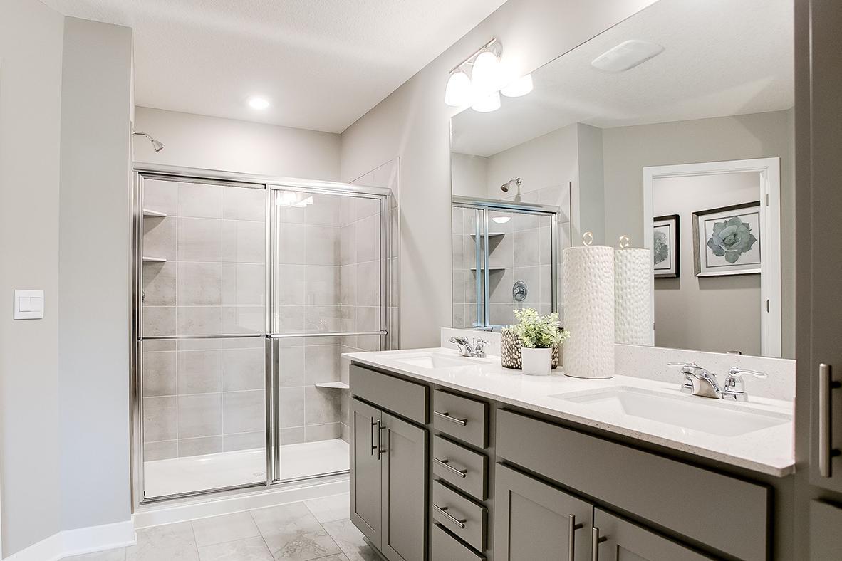 An extension of the primary suite, this private and spacious bathroom contains a double-vanity, an oversized stand-in shower, private stool room and access to the suite's second walk-in closet!!