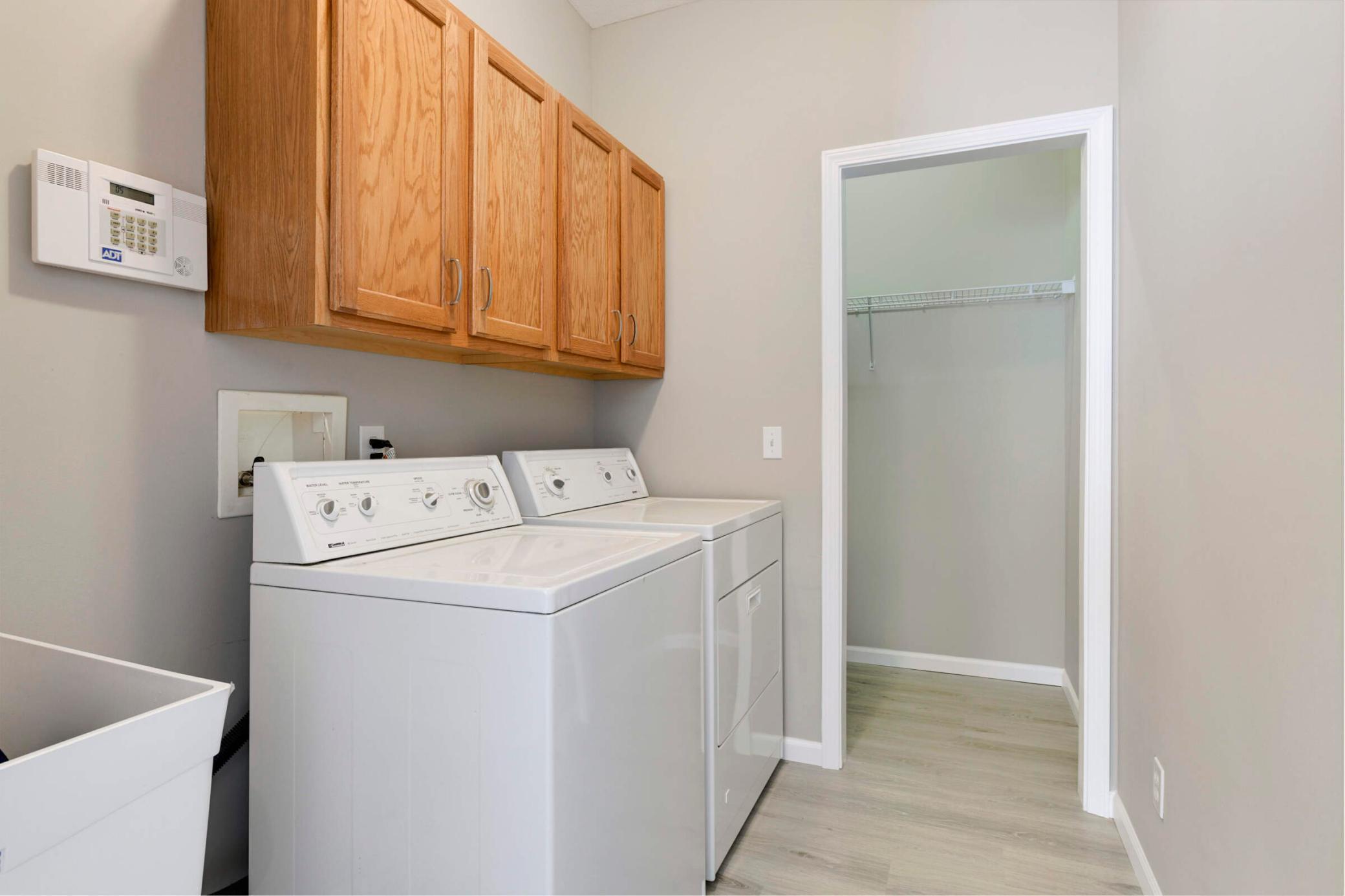 Laundry room with sink and coat closet on the main level