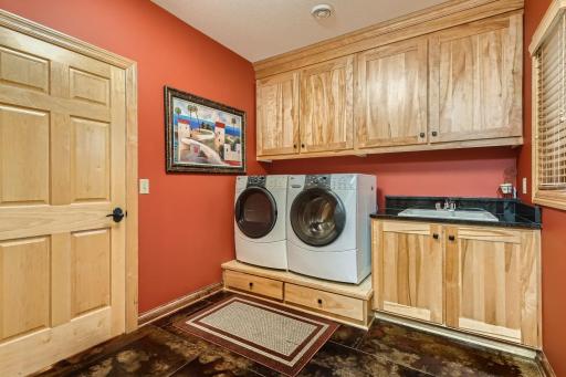 Main floor laundry room area off the garage. All living facilities are on one level if you are looking for that feature. Mud room has lockers and a large walk in closet + a utility closet as well