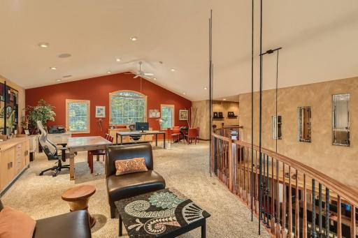 Now lets head upstairs to one of the most unique feature in this home. Check out this architecturally designed suspended loft area. As you can see, it is not your typical loft space in size & it has beautiful wood railing that overlooks the main lvl