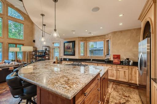 Large curved center island with cooktop, blt in drawers and tons of cabinets on the front to store all those appliances you don't use on a day to day basis. You can countertop room to spare. A gourmet kitchen for the chef who like to cook