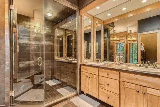 Owners bath has walk in steam shower, double sinks, mirrors open to double medicine cabinets, heated tile floor & step down corner tub.