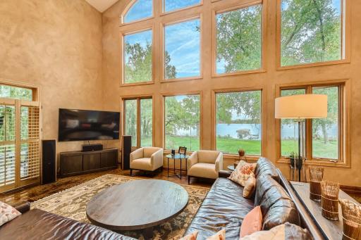 Can you picture yourself laying on the couch looking out at this view. It would never get old. On both sides of this family room you will find plantation style shutters that open doors that lead to the backyard/lakeside area of the yard