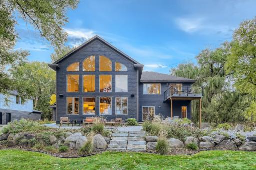 Back of the home view. Not only is the house architecturally appealing, but the boulder walls and landscaping are stunning