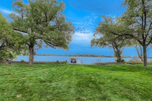 A lot of people love the idea of living on the lake but hate to have to go down stairs to get to the water, You don't have that problem here. This is a nice level lot all the way to the water. Gorgeous