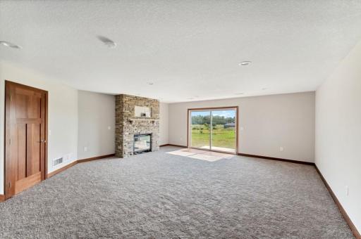 Family room with stone fireplace where you can step right into the backyard