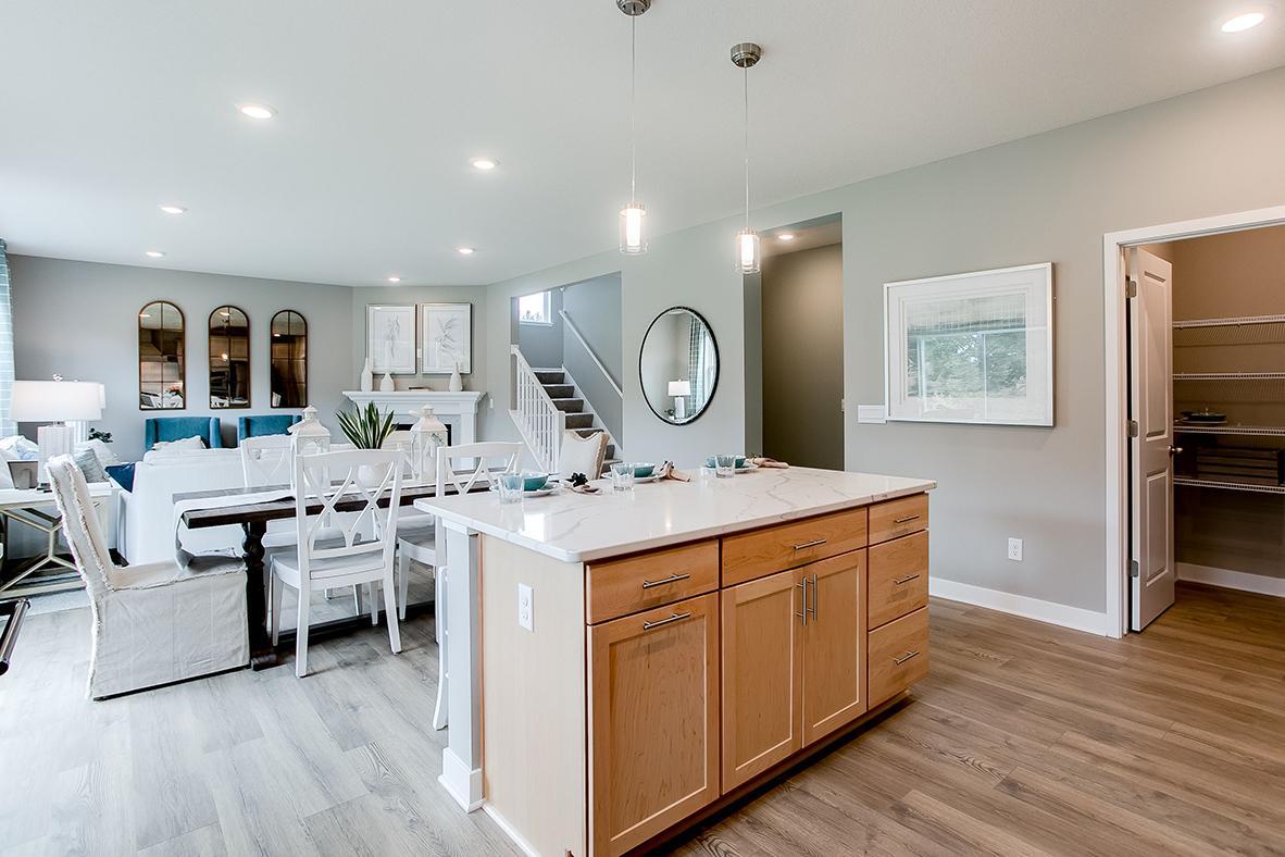 The open-concept floor plan epitomizes itself in a plan that flows seamlessly from kitchen to dining to the family room! (Photo of model)