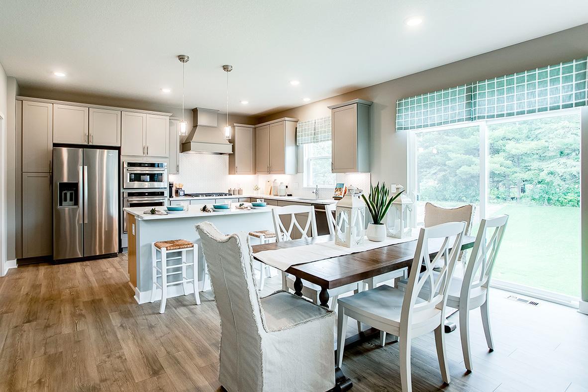 The kitchen space flows conveniently into the dining area, which leaves enough space to accommodate any dining table configuration! (Photo of model)