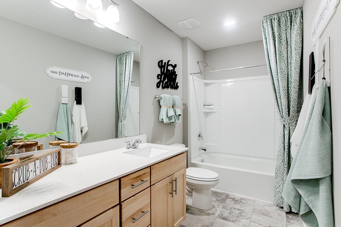 Those bedrooms each have easy access to this deep and spacious bathroom! (Photo of model)