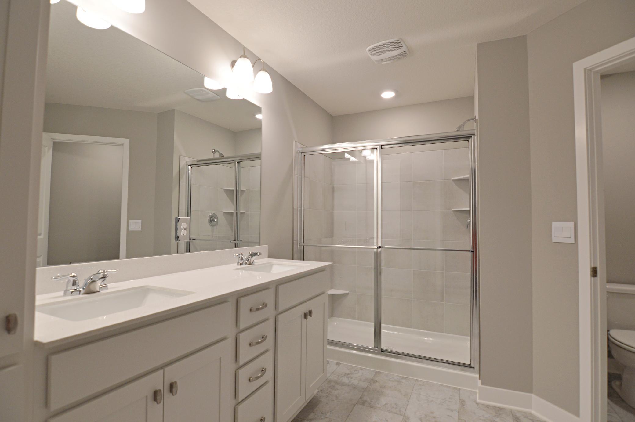 An extension of the primary suite, this private and spacious bathroom contains a double-vanity, an oversized stand-in shower, private stool room and access to the suite's second walk-in closet!!