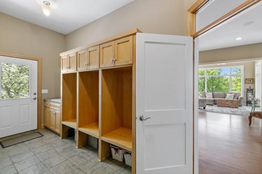 Mud Room with access to attached 3 car garage; 3 lockers, planning desk and utility sink