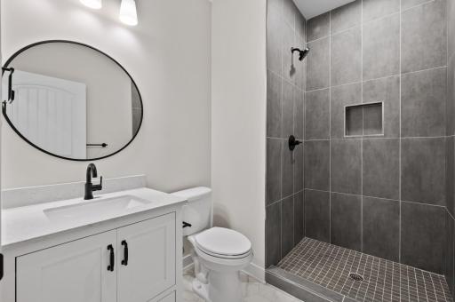 Lower level bathroom with fully tiled shower