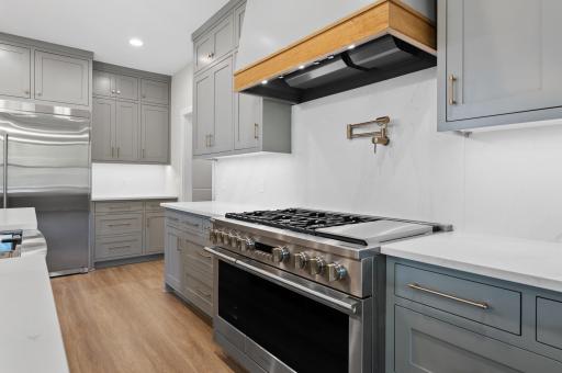 Kitchen with oversized stove and custom built in hood