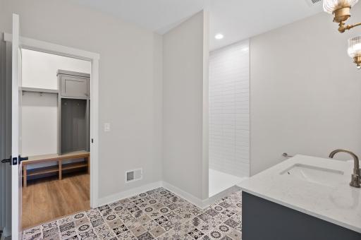 Main level 3/4 bathroom with fully tiled shower