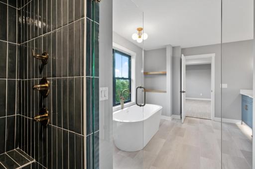 Upper level primary bathroom with separate soaking tub