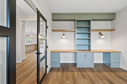 Front office with custom cabinet built-ins and modern lighting
