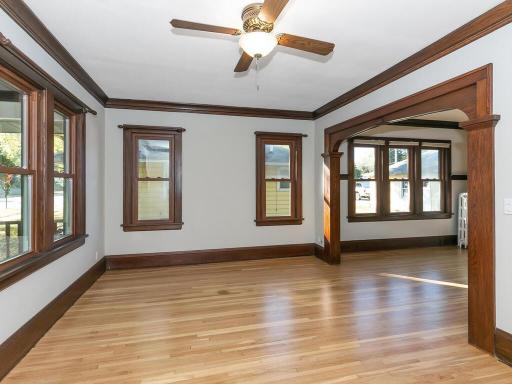 Tons of character and charm is present with the tall baseboard, crown molding, and trimmed-out archways.