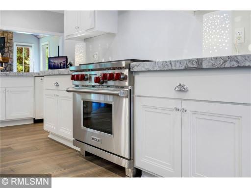 This home boasts a high-end Wolf stove. Notice also the crystal door knobs and polished chrome drawer pulls. Beautiful.