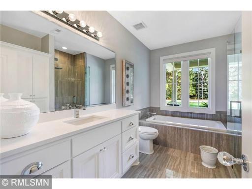 Just outside the second bedroom you will find this masterfully planned full bathroom with separate shower and tub.