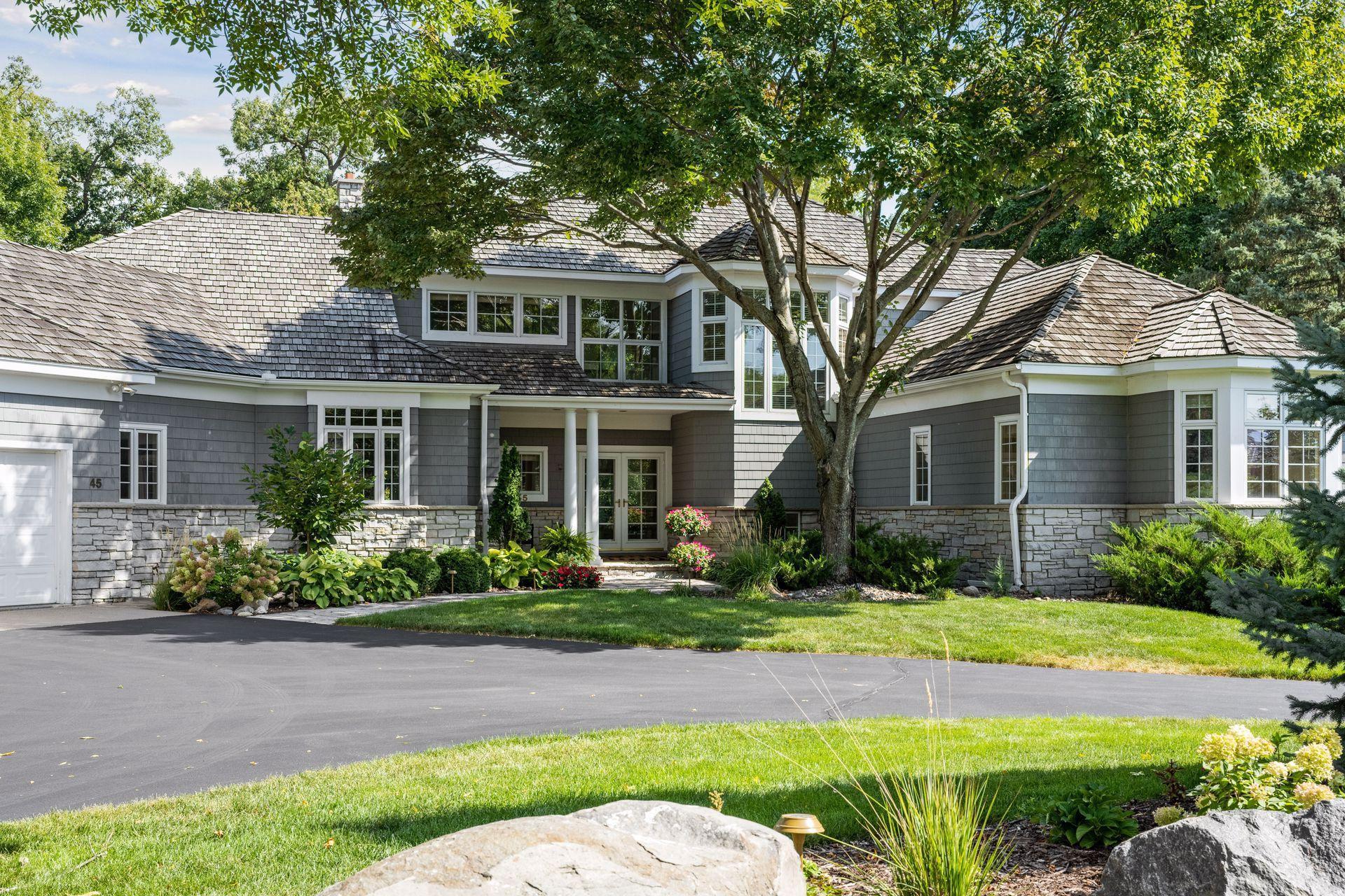 Lovely curb appeal with shake siding, cedar shake roof, and perfect landscaping.
