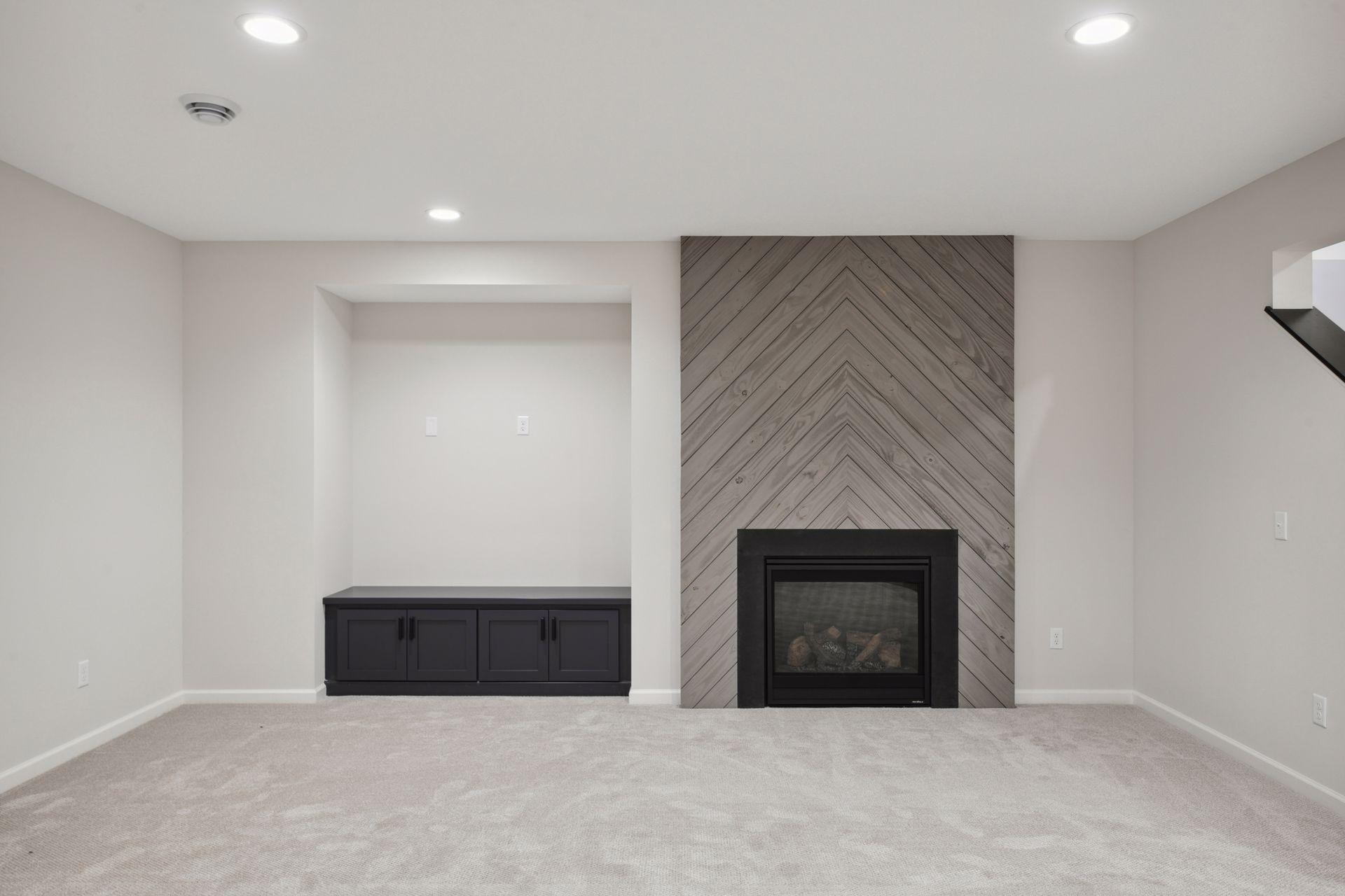 Lower level fireplace with built-in and custom wood shiplap