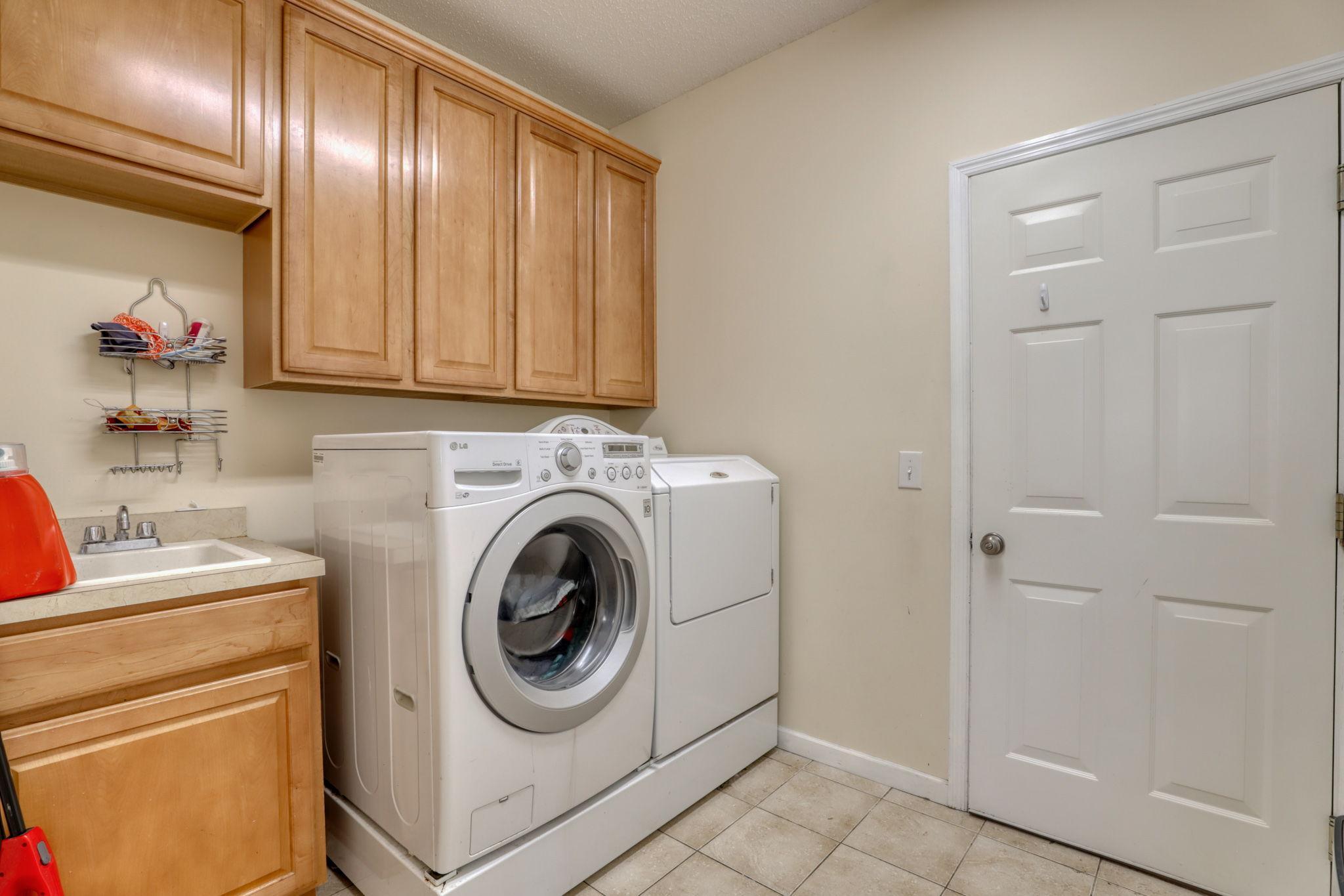 Laundry/mud room between kitchen and garage.