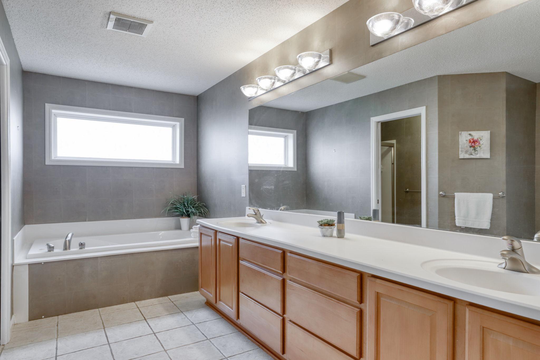 Owners' suite bath with double sinks, lots of counter space, jetted soaking tub and separate step-in shower.