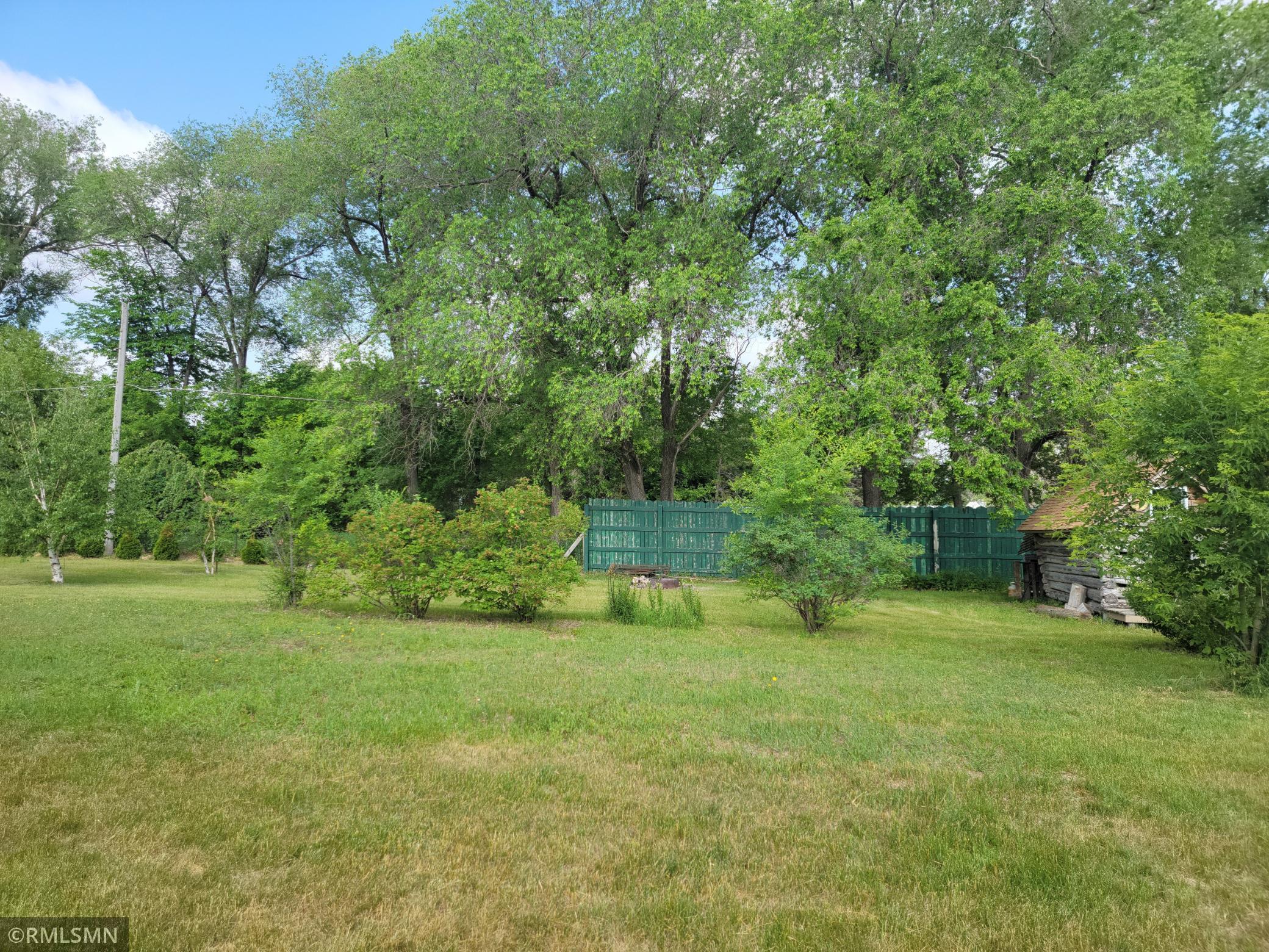 This property has a big yard with nice trees.