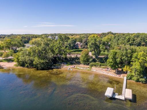 The property features over 140-feet of riprapped shoreline with a sandy bottom.