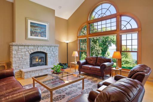 The vaulted great room features an oversized window that looks out to the lake.