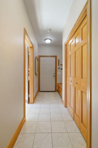 There is ample storage in this mud room which features two coat closets, a broom closet and built-in boot bench.