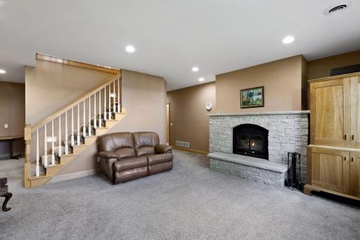 The lower level family room enjoys a second wood burning fireplace.