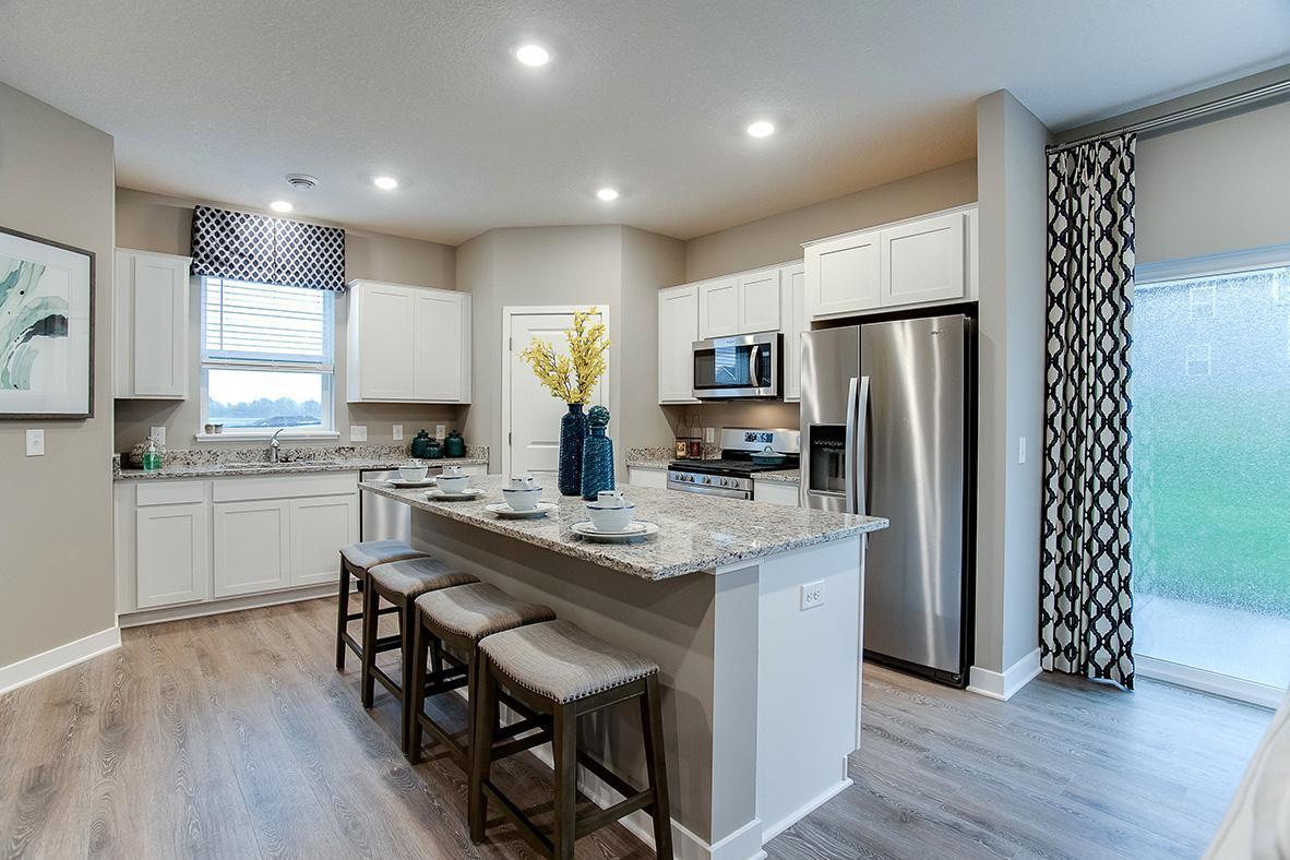 Enjoy having beautiful granite counters with space for four to sit, and a great kitchen that includes stainless appliances and walk in pantry. * fridge not included