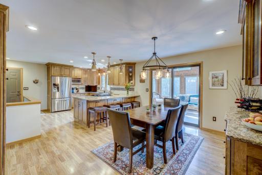 Enjoy an open-concept, fully remodeled kitchen & dining room complete with Cambria countertops & custom cabinetry offering ample storage.