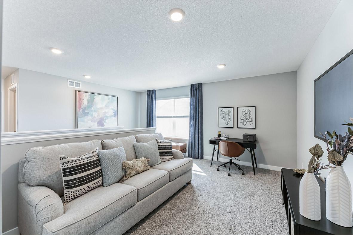 Located on the upper level, this perfectly sized living space has enough room for a desk, television, and seating. Plus, it is just steps away from all four bedrooms.