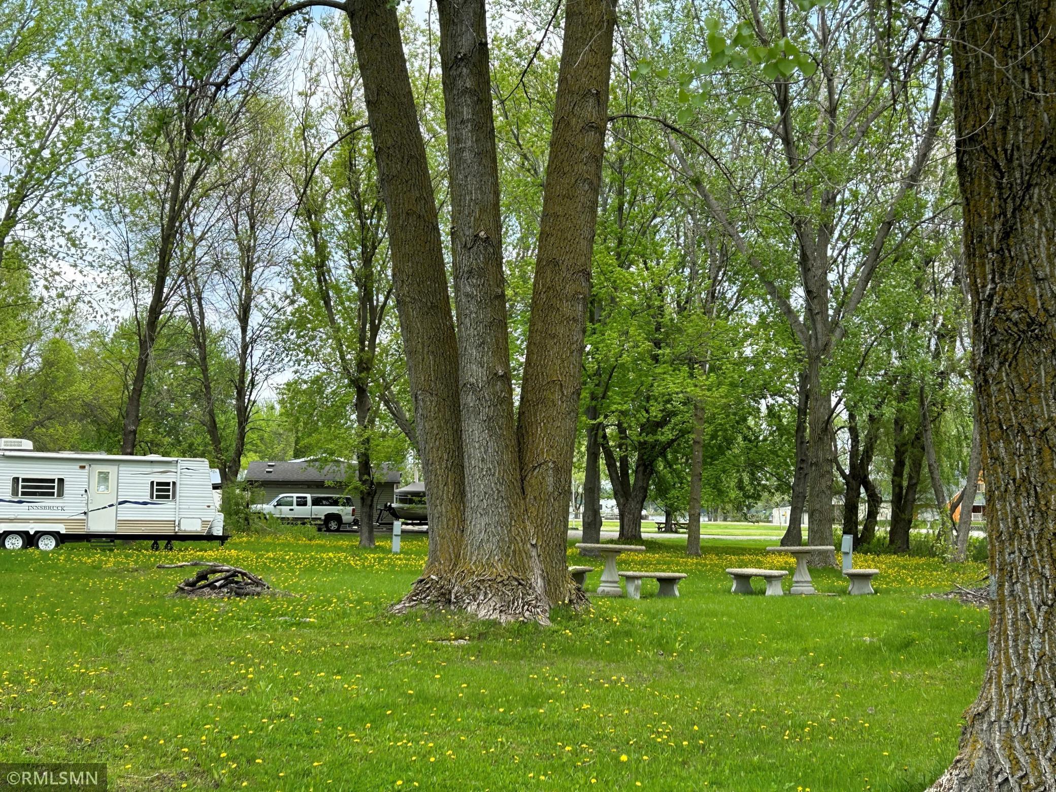 Shade trees and open space for camping and yard games. There are 3 electrical hook-ups for campers. Camper not included