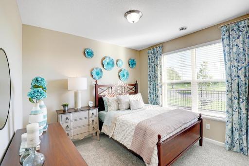 Each of the two additional bedrooms are abundant in size. Model photo. Options and colors will vary.