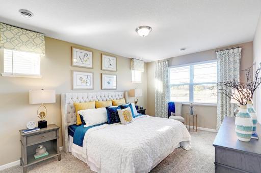 Plenty of natural light in the large primary bedroom suite. Model photos. Options and colors will vary.