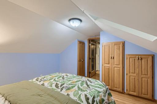 Built-ins, skylight, and vaulted ceiling in upstairs primary bedroom