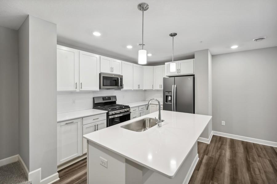 Welcome to the Revere! Stunning kitchen with Stainless Slate appliances and white cabinetry brighten up the space. *Photos are of another model, colors and finishes may vary.