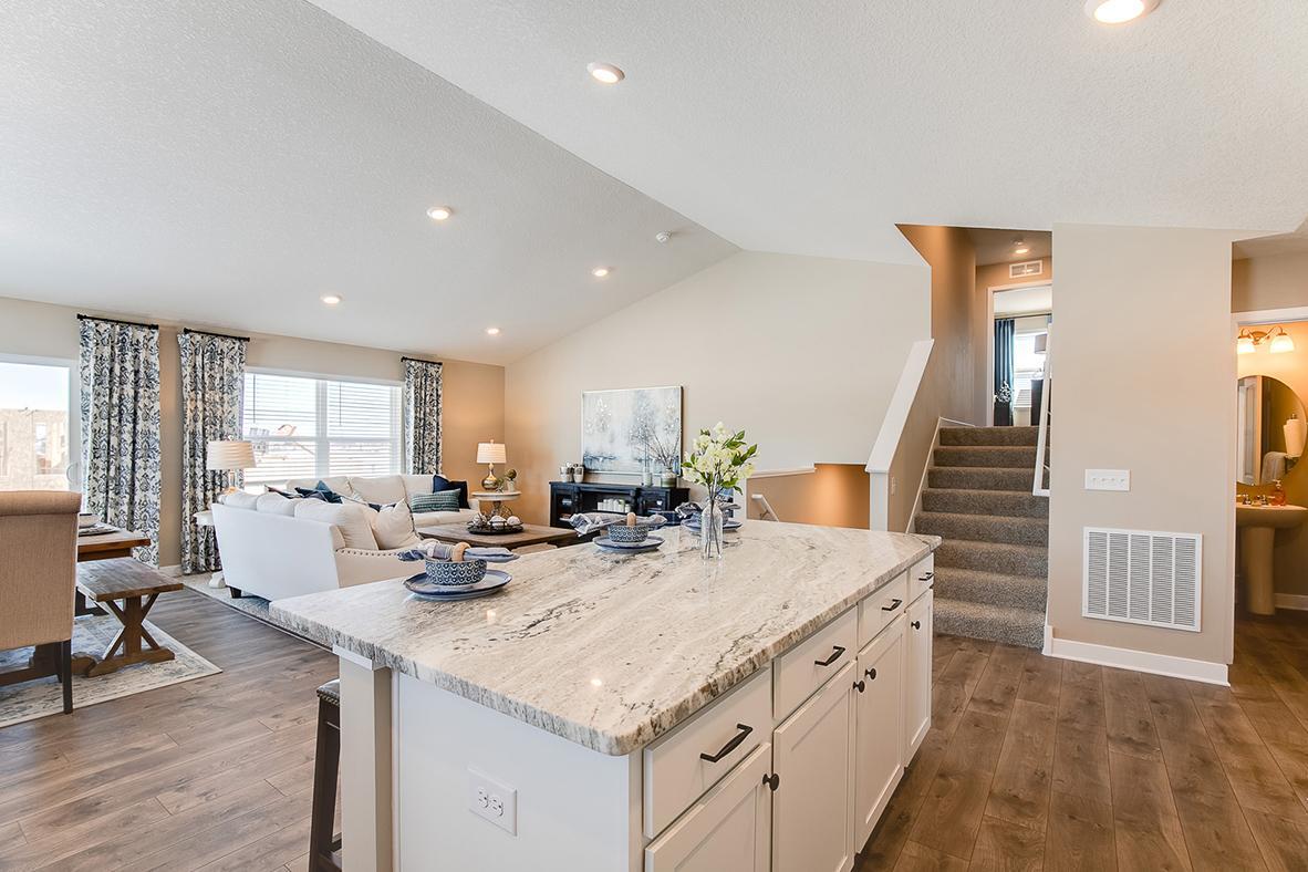 A view from the kitchen, you can see the open and interconnected main level. Model home photo, colors and selections may vary.