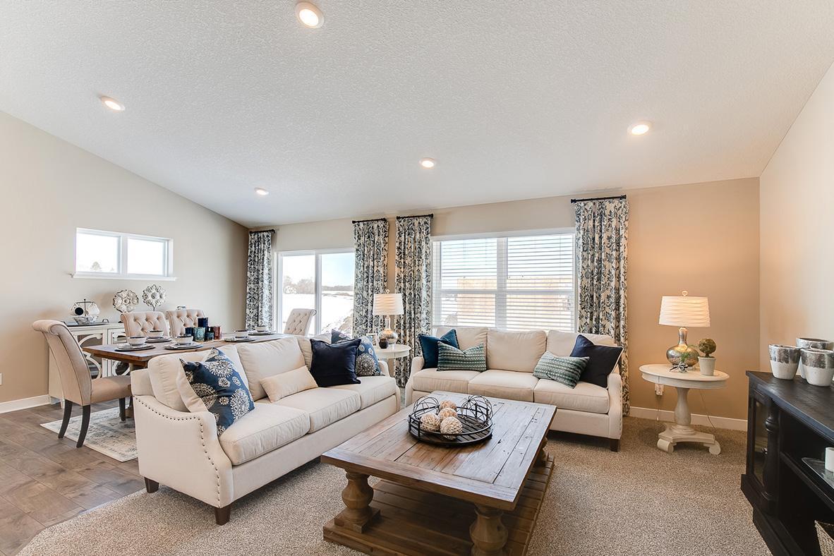 Main level living room area, enough space to accommodate many different furniture arrangements. Model home photo, colors and selections may vary.