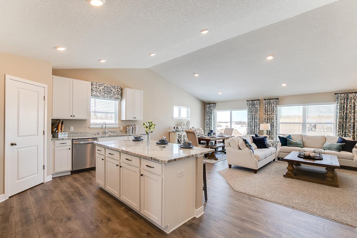 The vaulted ceiling adds to the open and spacious feel this main level offers. Model home photo, colors and selections may vary.