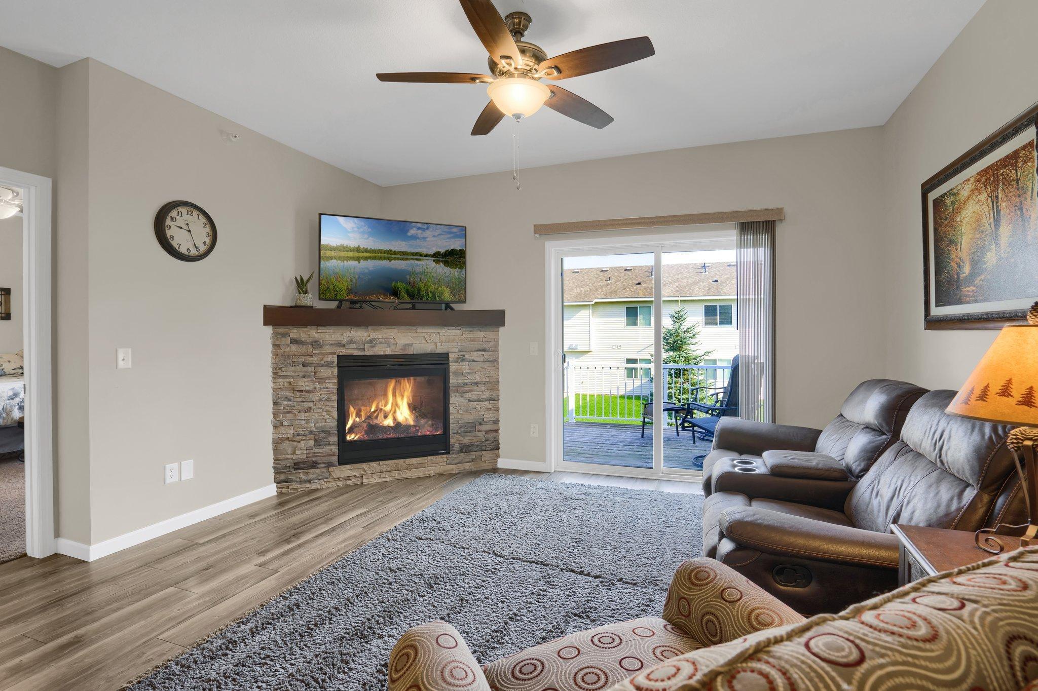 Spacious main level living room with fireplace and walk out to your private deck
