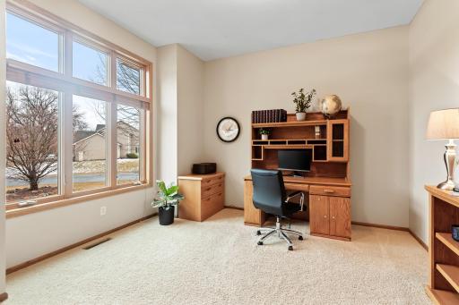 The front room is a perfect setting for a home office with high ceilings and oversized windows filling the room with natural light. A perfect view to the front yard to conveniently keep an eye on the family.