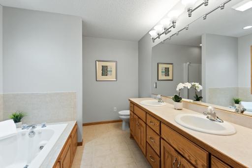Private bathroom for the primary bedroom with separate shower, dual sinks, fresh paint and jetted whirlpool for relaxing moments.