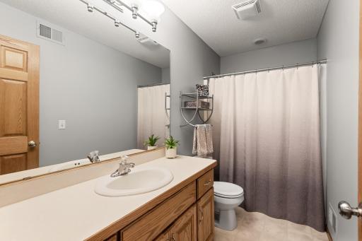 Main full bathroom on upper level with large vanity for those busy mornings.