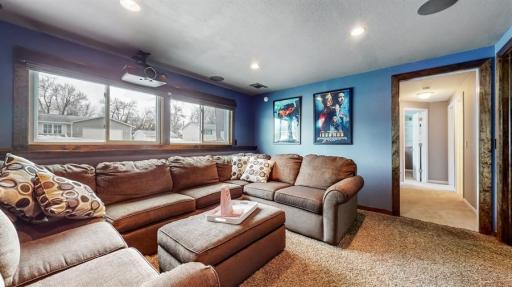 Lower level features media room, 2 additional bedrooms, bathroom, laundry and storage space.